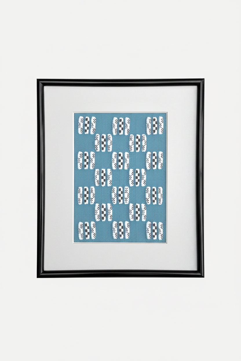 Framed artwork with a blue pattern on a white background