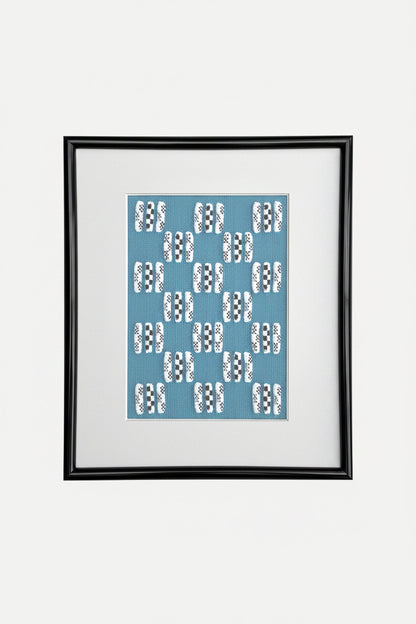 Framed artwork with a blue pattern on a white background