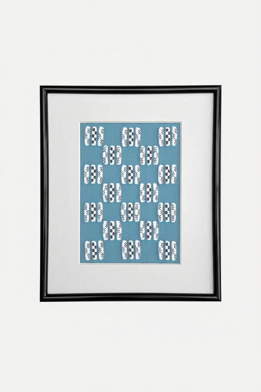 Framed artwork with a blue pattern on a white background