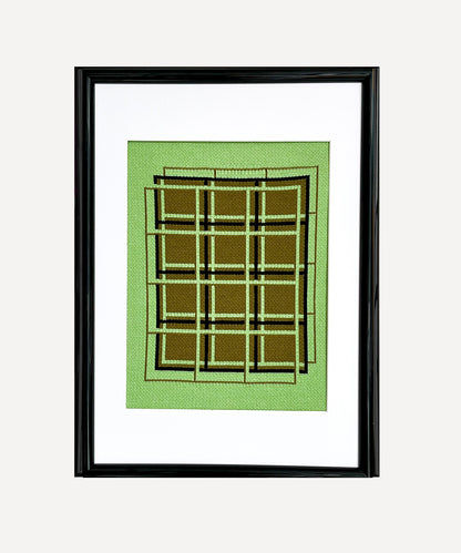 Framed artwork with geometric design on a green background