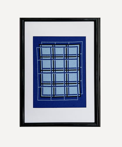Framed artwork with blue plaid pattern on a white background