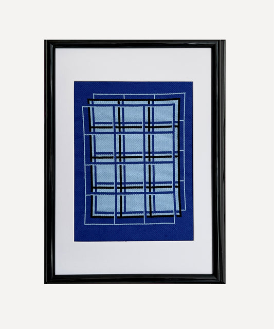 Framed artwork with blue plaid pattern on a white background