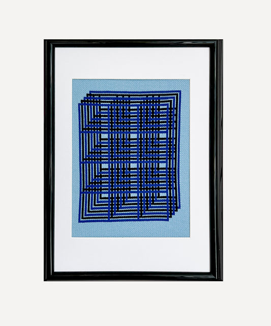 Framed abstract artwork with blue geometric design on a light blue background