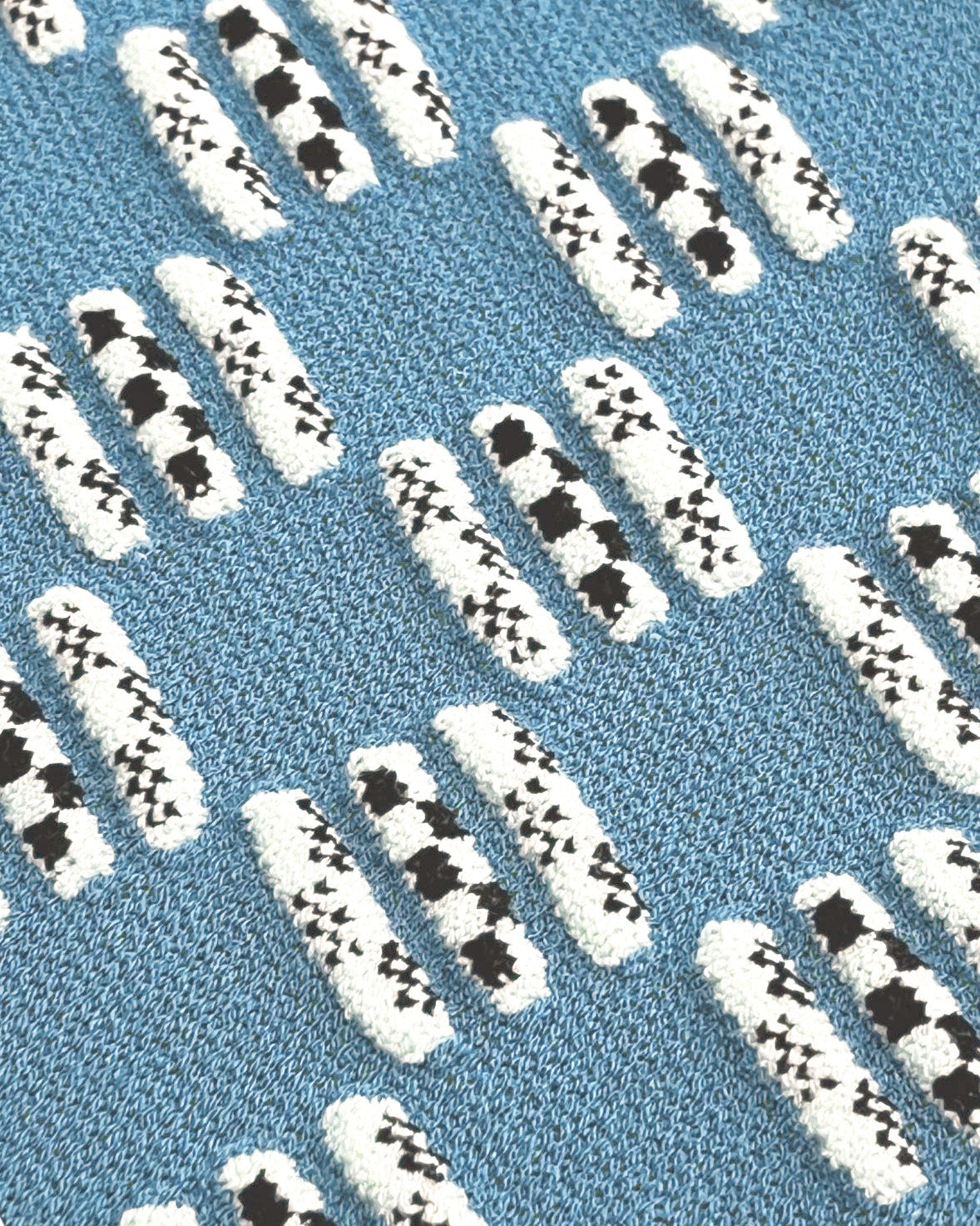 Patterned blue rug with white and black designs