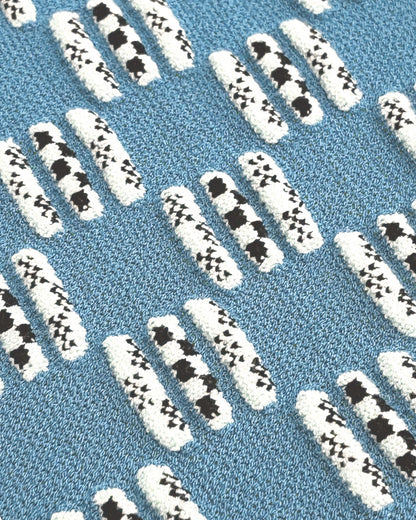 Patterned blue rug with white and black designs
