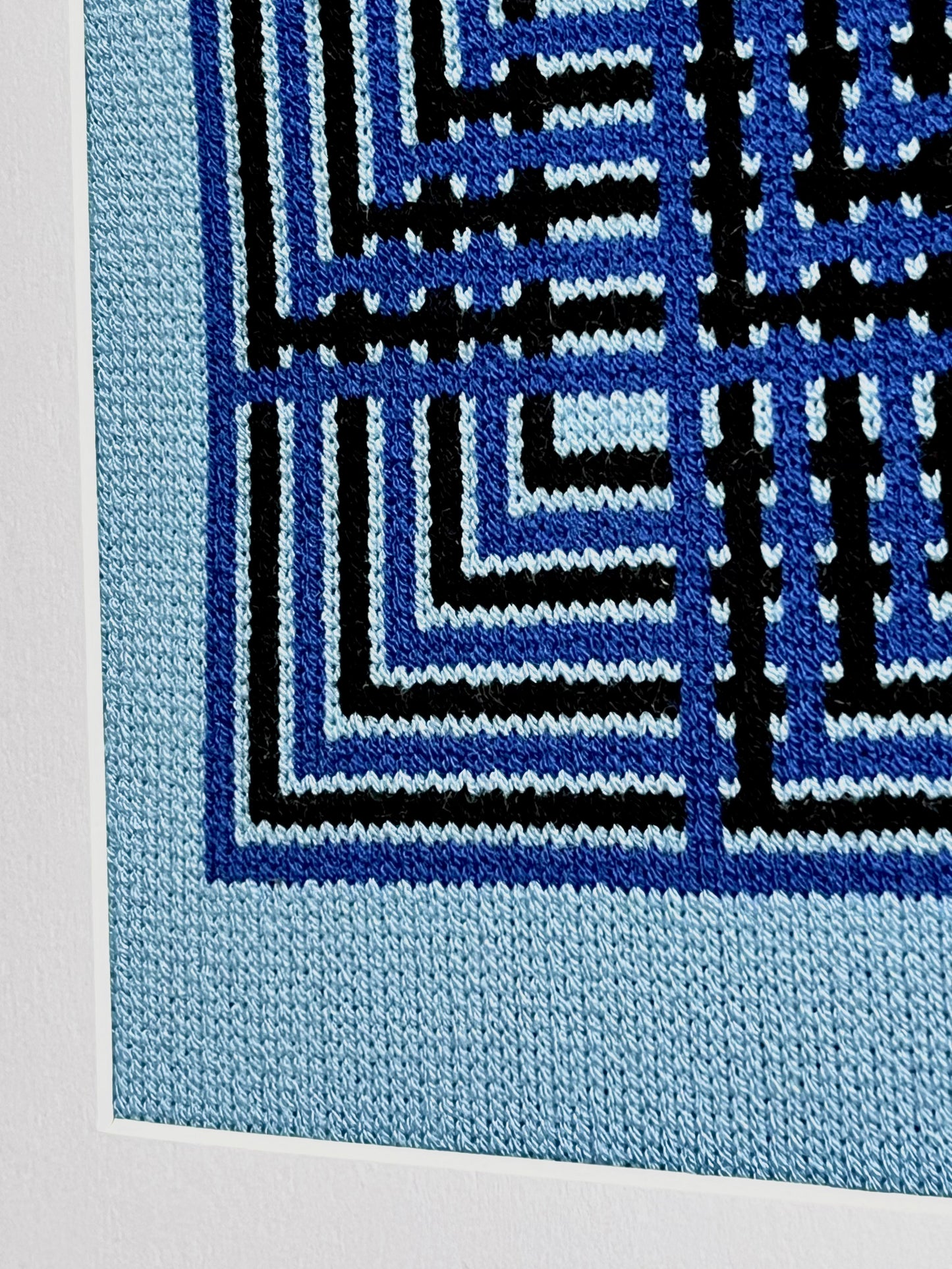 Close-up of a blue and black geometric patterned fabric