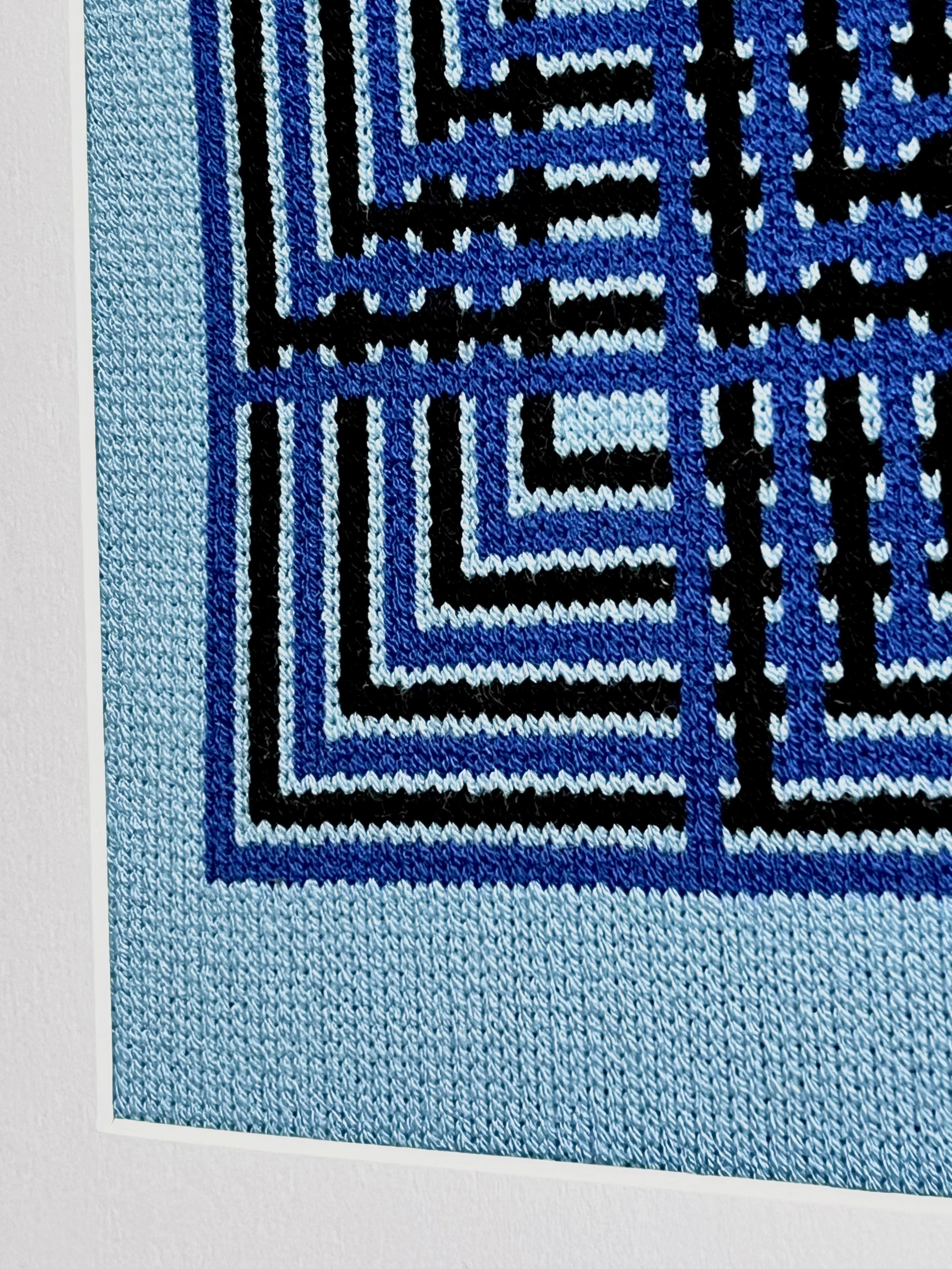 Close-up of a blue and black geometric patterned fabric
