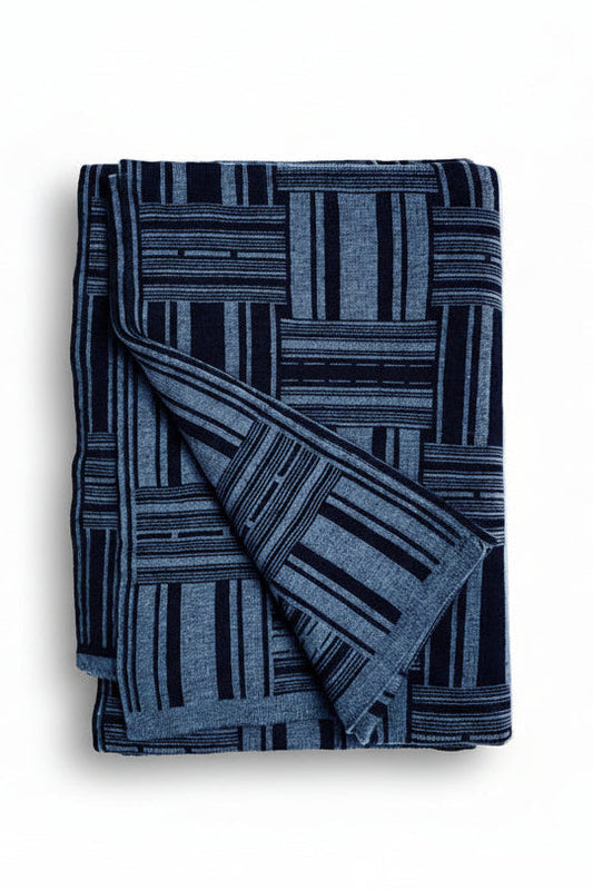 Folded blue patterned blanket on a white background