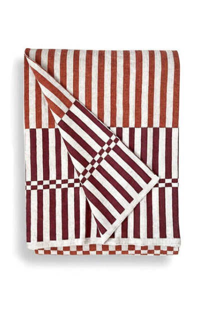 Folded red and white striped fabric on a white background